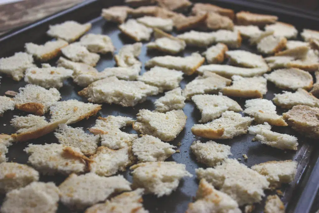 The bread chunks are on a baking sheet and ready to go in the oven to get nice and dry.